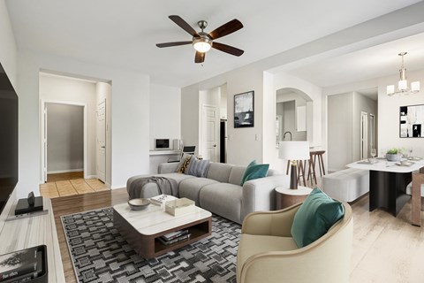 A modern living room with a grey sofa and a wooden coffee table.