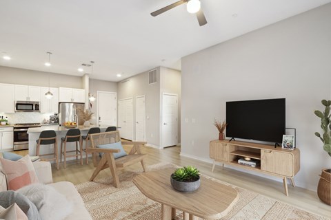 A modern living room with a wooden coffee table and a flat screen TV.