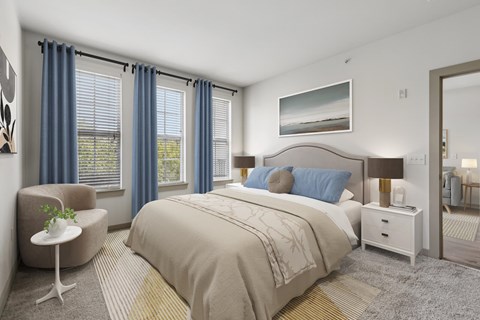A bedroom with a large bed, a chair, and a painting on the wall.