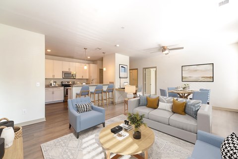 A living room with a grey couch and a coffee table.