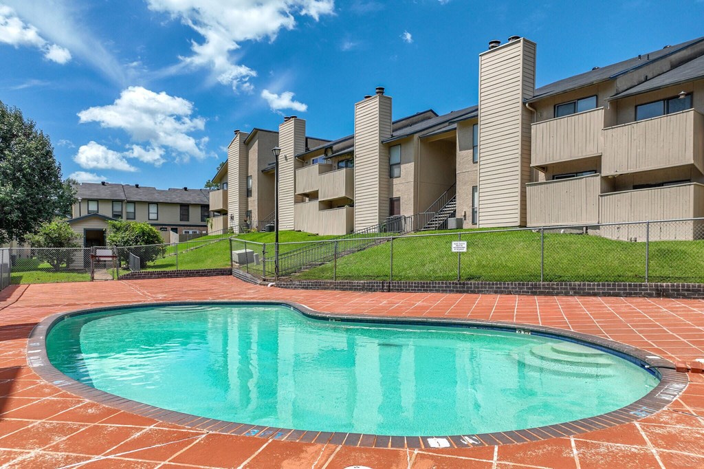 A swimming pool in front of apartment buildings.