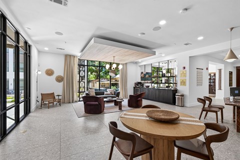 A modern living room with a large wooden table and chairs.
