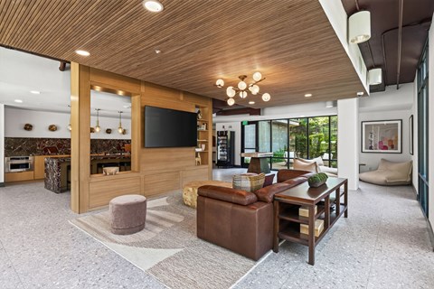 A modern living room with a wooden ceiling and a large sectional sofa.