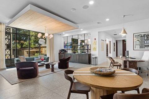 A modern living room with a wooden table and chairs.