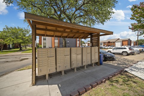 A wooden structure with a roof and a row of lockers in front of it.