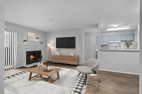 A modern living room with a fireplace and a flat screen TV.