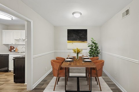 A dining room with a wooden table and chairs.
