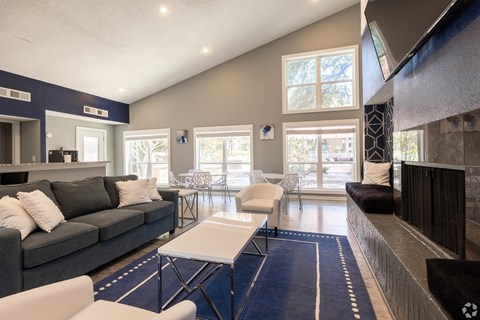 A living room with a grey couch and a white coffee table.