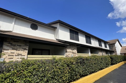 A building with a stone facade and a yellow line in front of it.