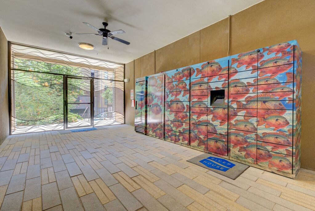 A room with a wall covered in a floral patterned wallpaper.