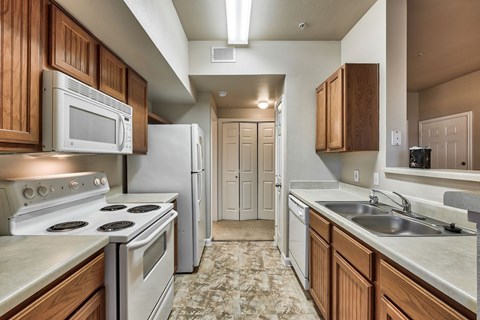 A kitchen with a stove top oven and microwave above it.
