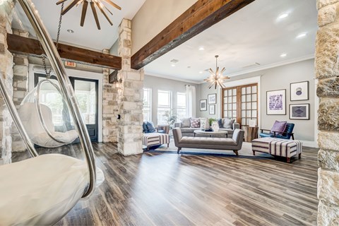 A modern living room with a wooden floor and a stone wall.