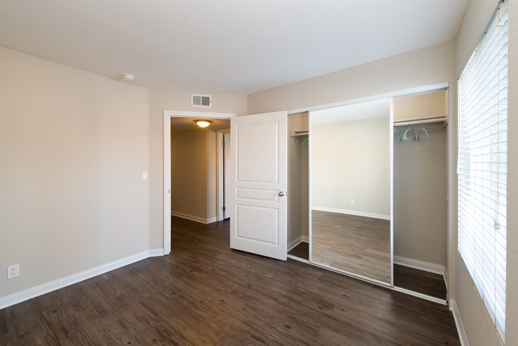 A room with a white door and a white closet.