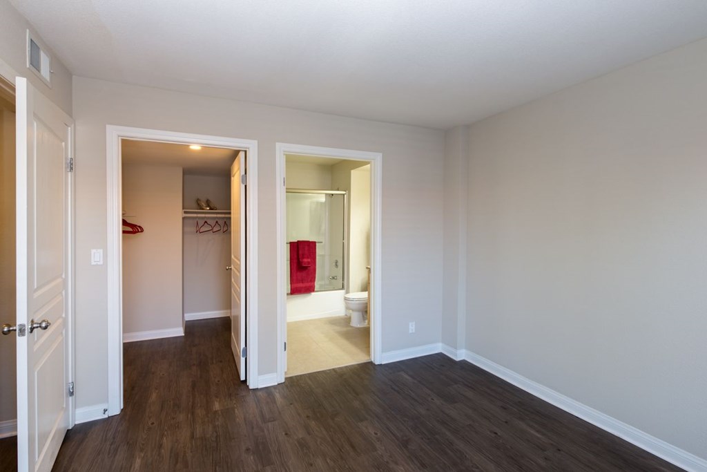 A room with a white wall and a wooden floor.