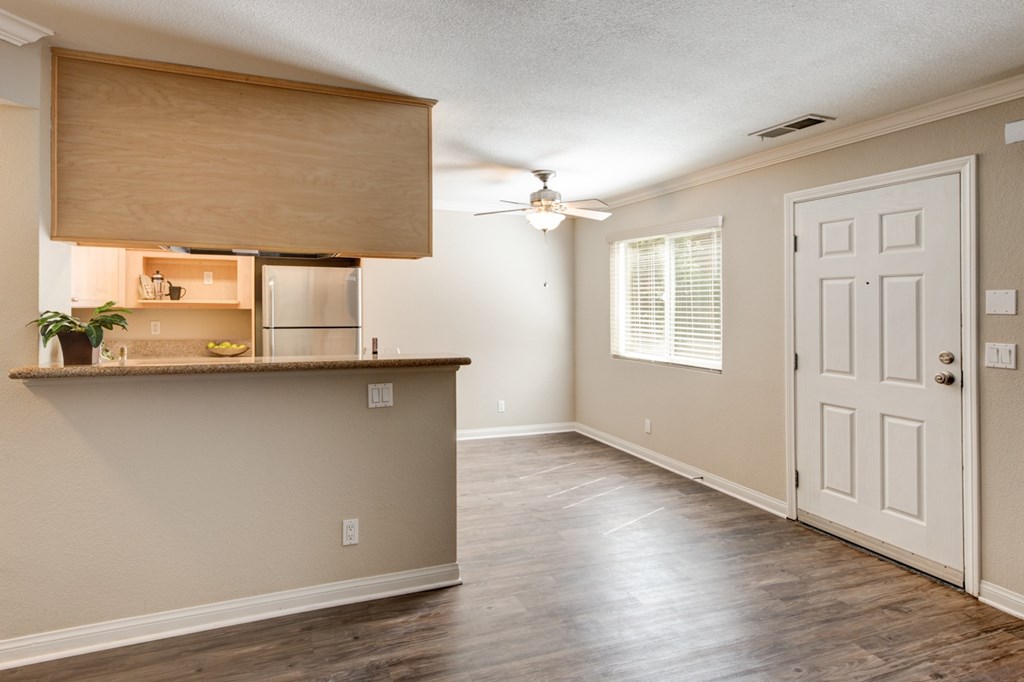A room with a wooden floor and a white door.