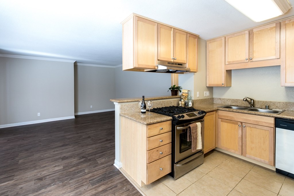 A kitchen with wooden cabinets and a black stove top oven.