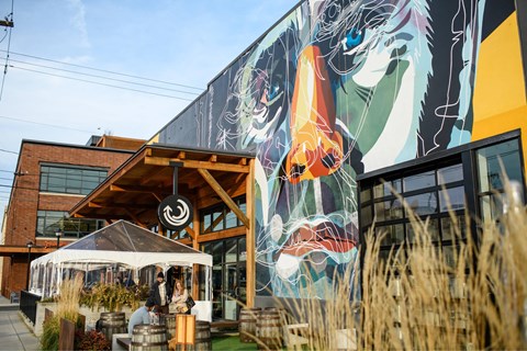 A mural of a dragon is on the side of a building.