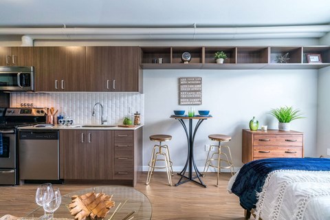 A modern kitchen with a dining table and chairs.