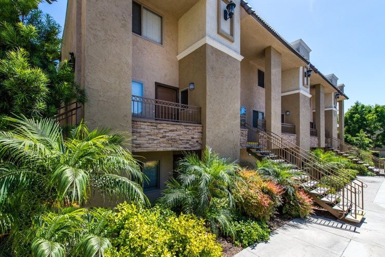 A building with a balcony and a metal railing.