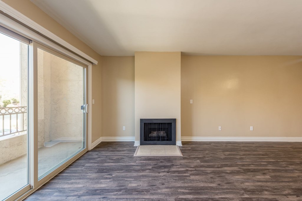 A living room with a fireplace and sliding glass doors.