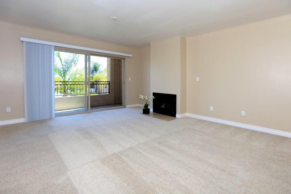 A living room with a fireplace and a sliding glass door.