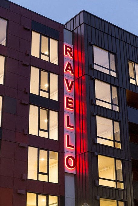 A building with the word  at Ravello Apartments, Redmond