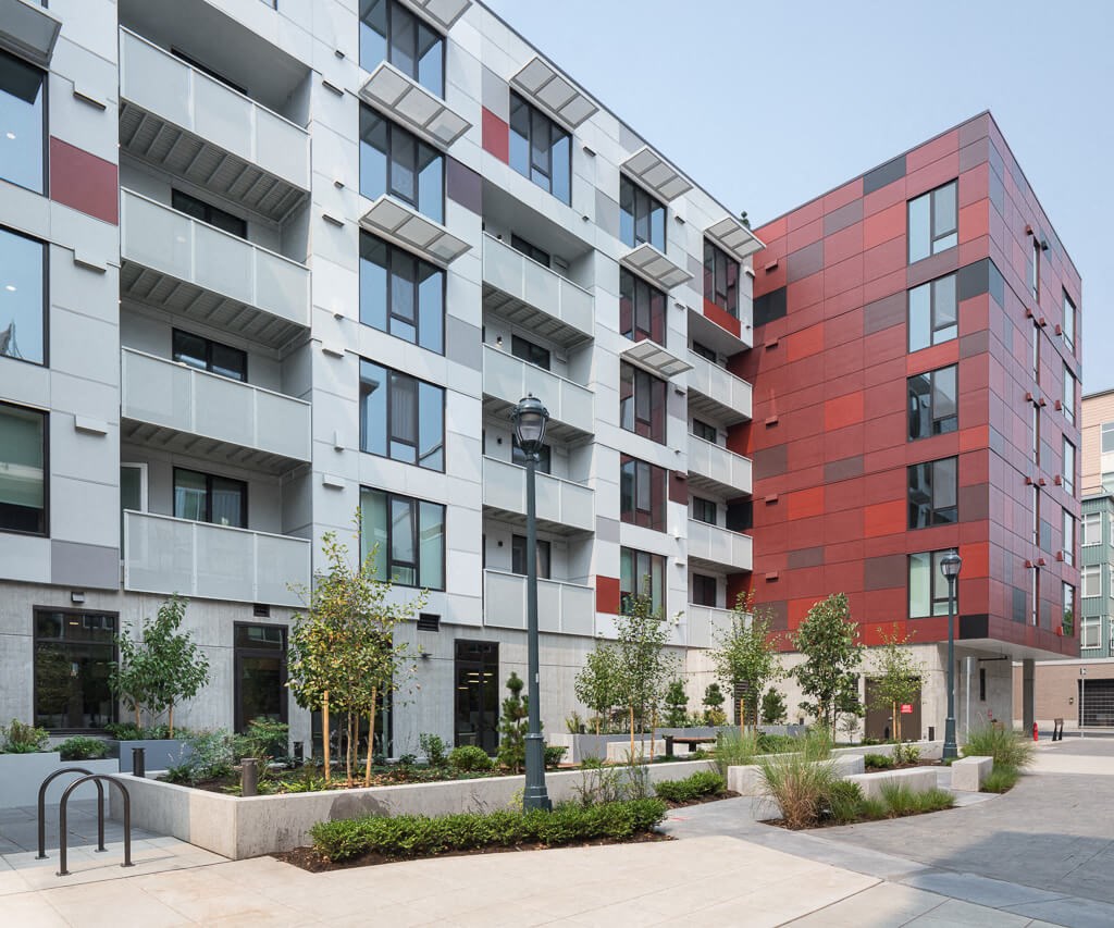A modern building with a red and grey facade. at Ravello Apartments, Washington, 98052