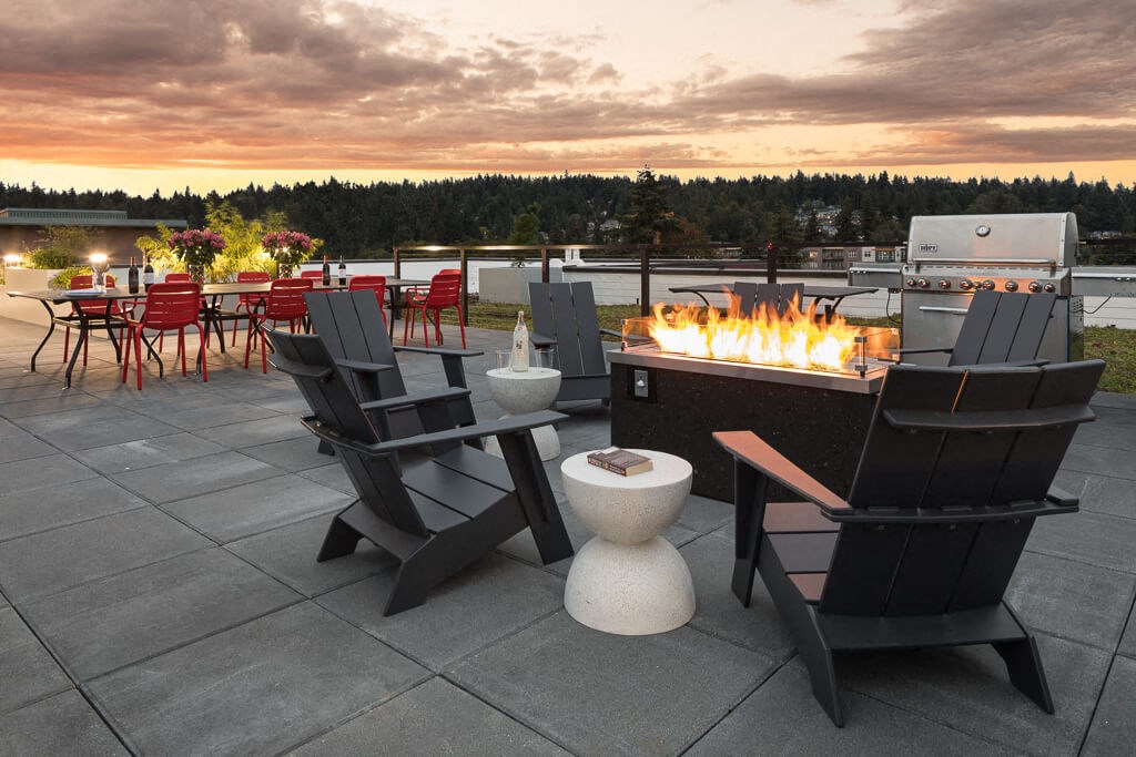 A patio with a fire pit and chairs. at Ravello Apartments, Redmond, WA, 98052