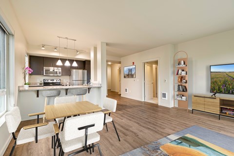 A modern kitchen with a dining table and chairs.