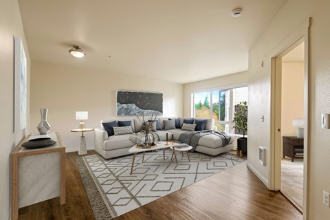 A modern living room with a large sectional sofa and a coffee table.