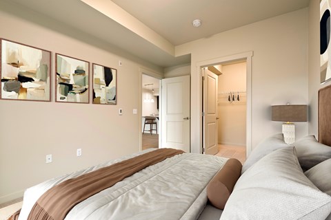 A bedroom with a large bed and a painting on the wall.