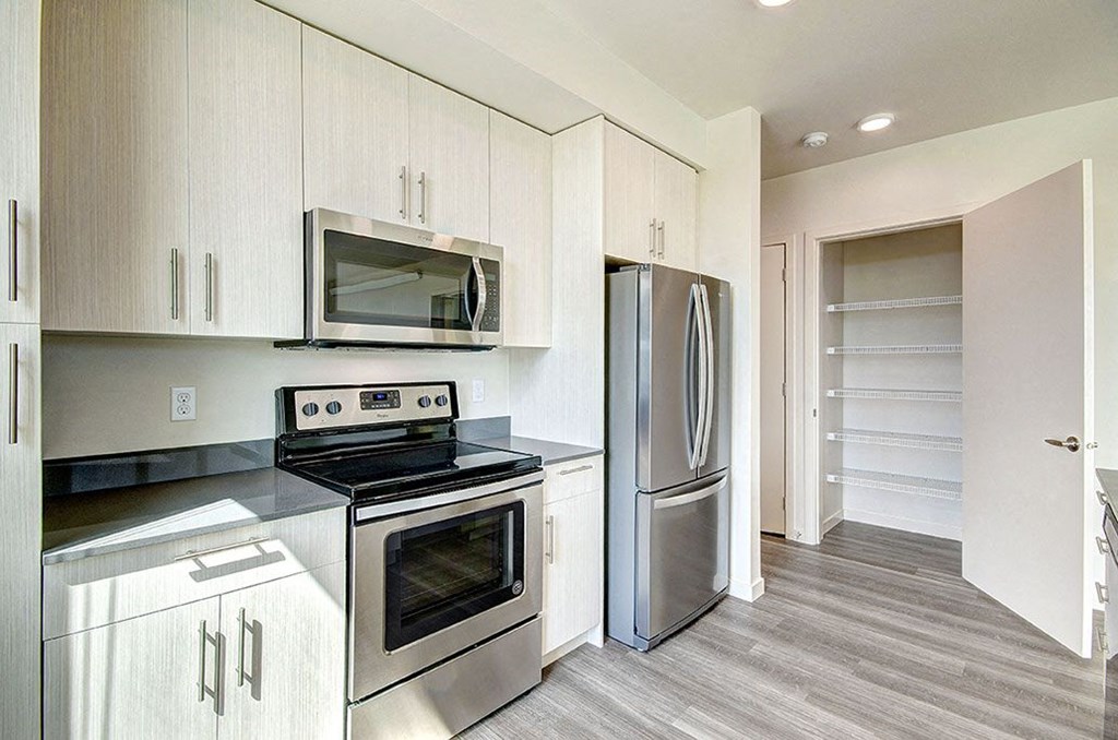 A kitchen with a stove, oven, and refrigerator. at Ravello Apartments, Redmond, WA, 98052