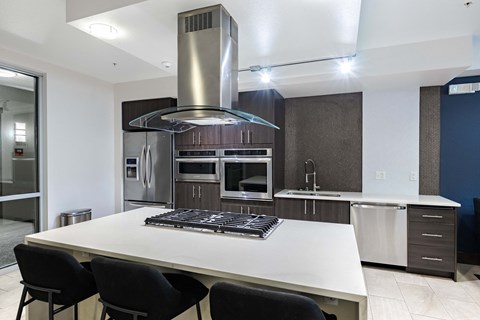 A modern kitchen with a large island and stainless steel appliances. at Kirkland Crossing Apartments, Kirkland