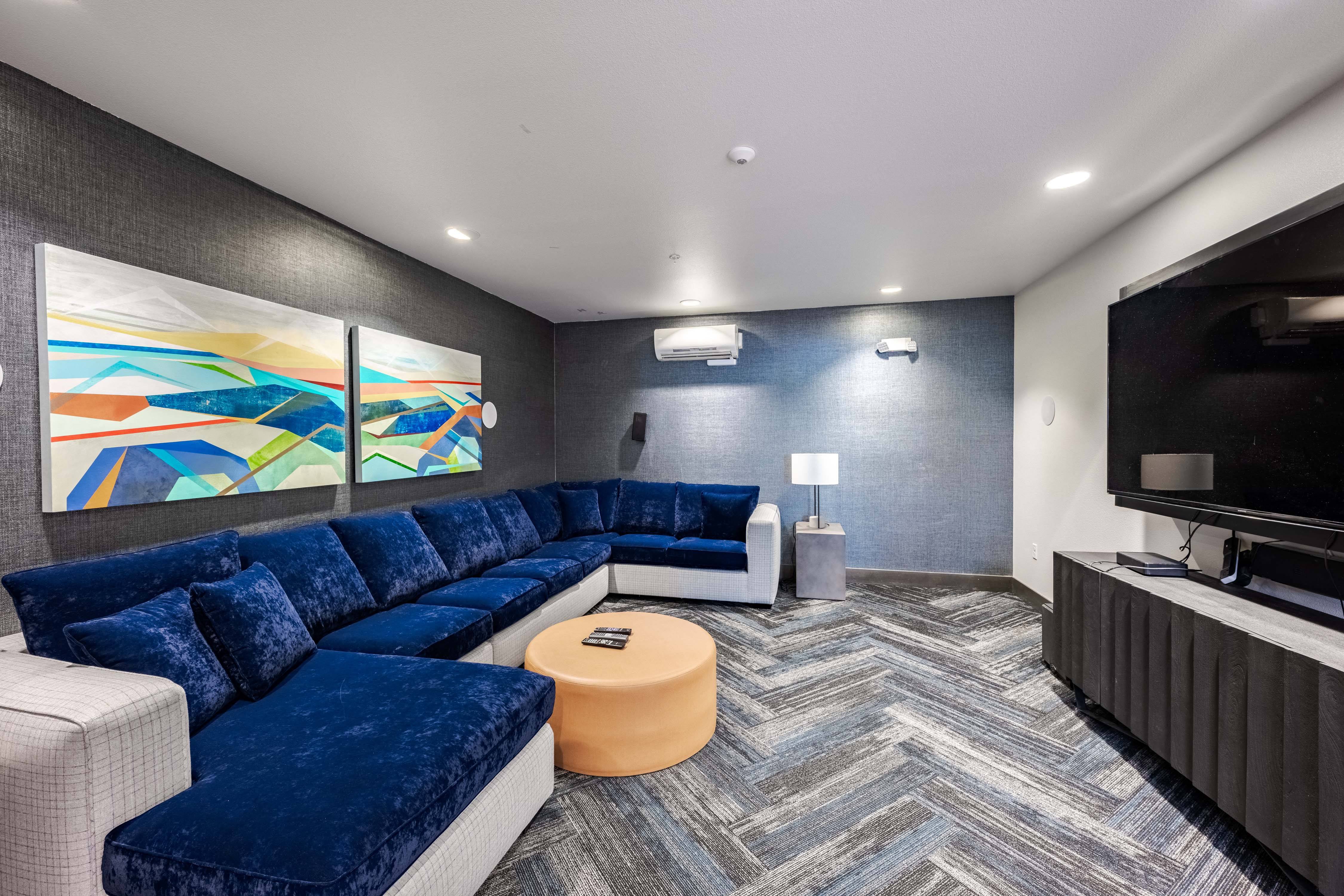 A living room with a blue couch and a television.