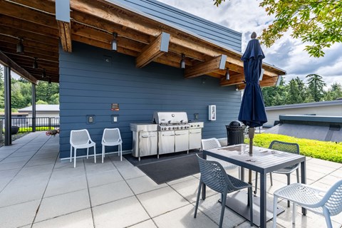 A blue patio with a table and chairs. at Kirkland Crossing Apartments, Washington