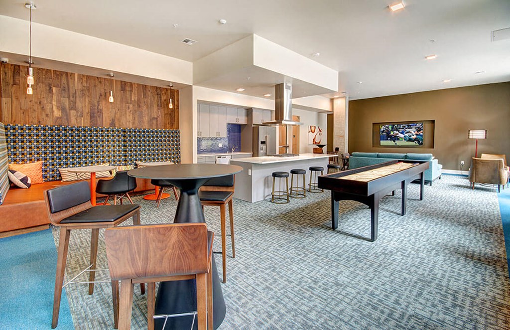 A modern room with a blue carpet and a wooden table. at Ravello Apartments, Redmond, Washington