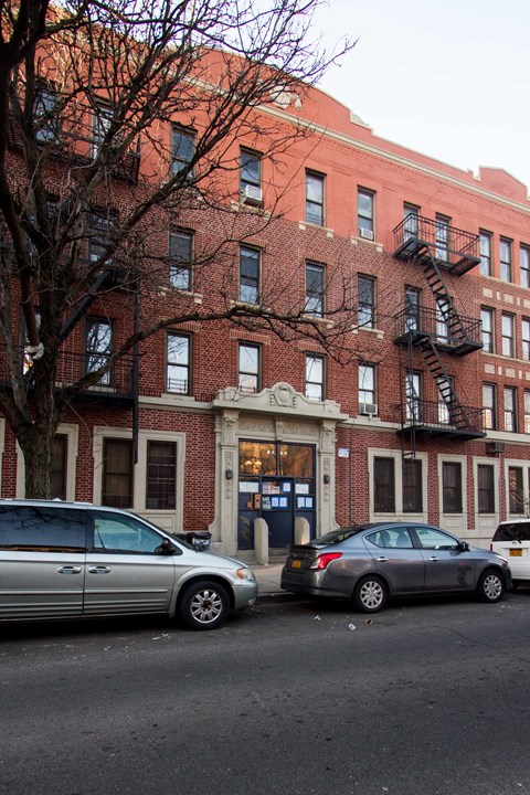 A red brick building with a white sign that says "RE" on it.