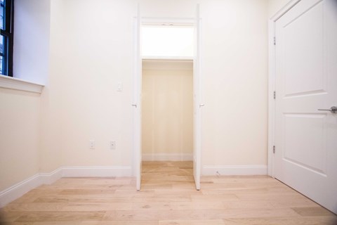 A room with a white door and a window.