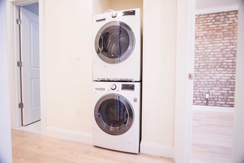Two washing machines in a laundry room.