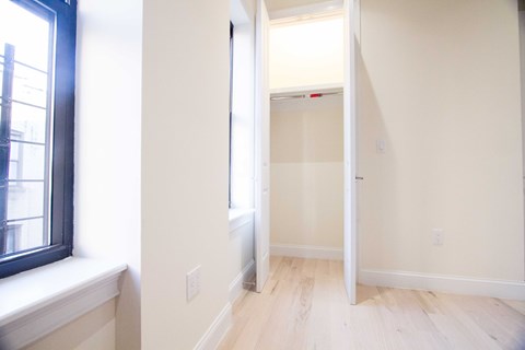 A room with a white door and a window.