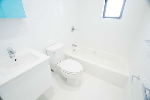 A white toilet and sink in a bathroom.