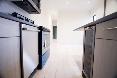 A modern kitchen with a black oven and a black microwave.