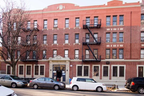A red brick building with a black fire escape.