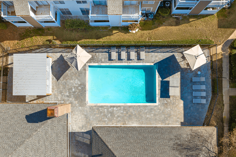 A swimming pool surrounded by a concrete patio and steps.