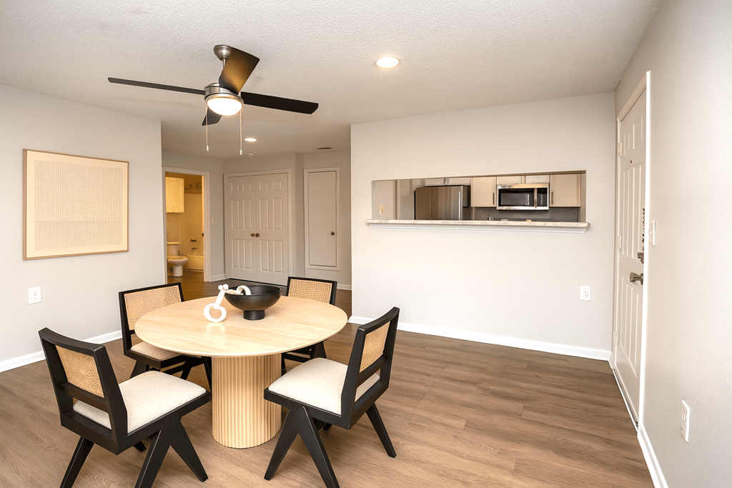 A dining room with a round table and chairs.