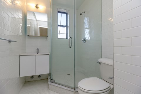 A white toilet in a bathroom with a glass shower door.