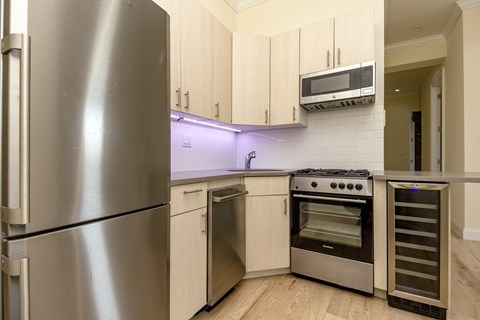 A kitchen with a stainless steel refrigerator and oven.