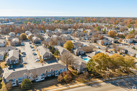 A bird's eye view of a residential area with houses and trees.