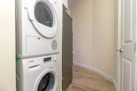 A white washing machine and dryer in a small room.