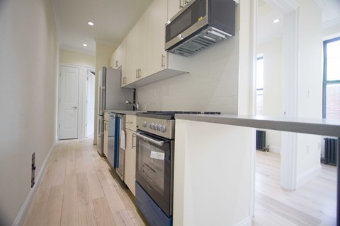 A modern kitchen with a stove top oven and a microwave.